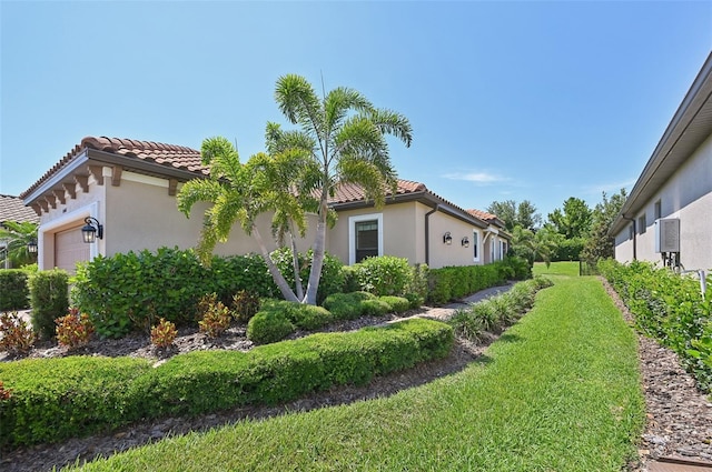 view of side of home with a lawn