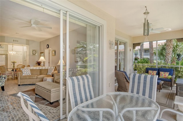 sunroom featuring ceiling fan