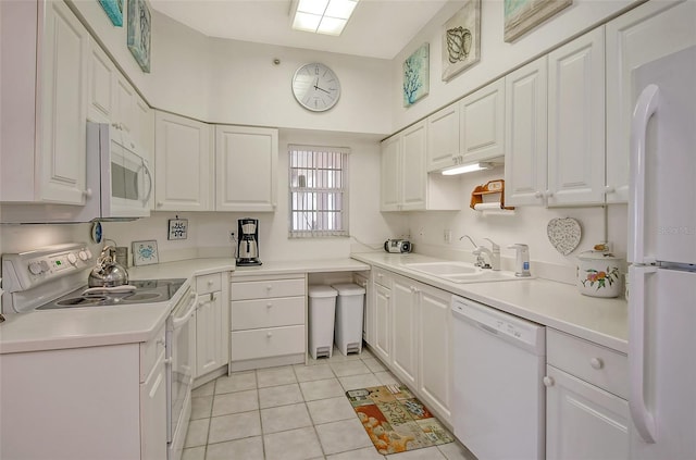 kitchen featuring white cabinetry, sink, white appliances, and light tile patterned floors