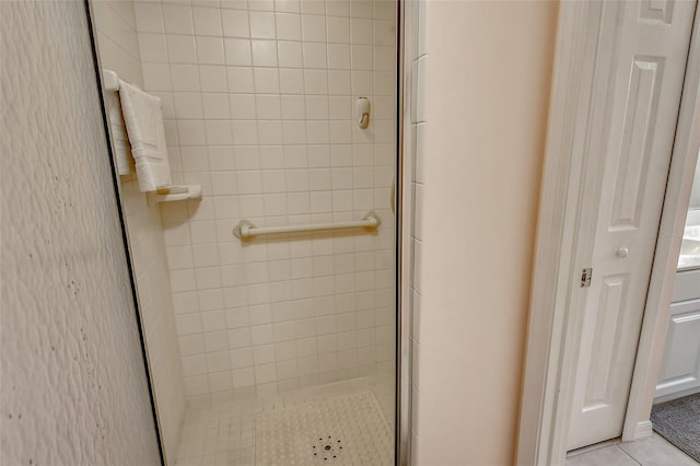 bathroom with tile patterned floors and a shower with door