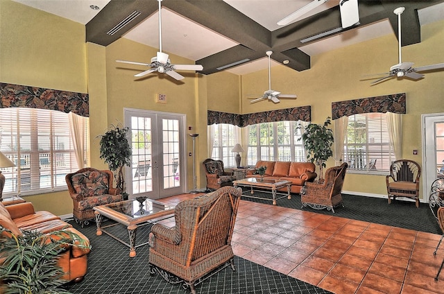 tiled living room with coffered ceiling, french doors, a healthy amount of sunlight, and beam ceiling