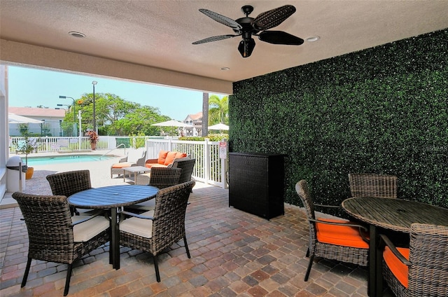 view of patio / terrace with a fenced in pool, ceiling fan, and an outdoor hangout area