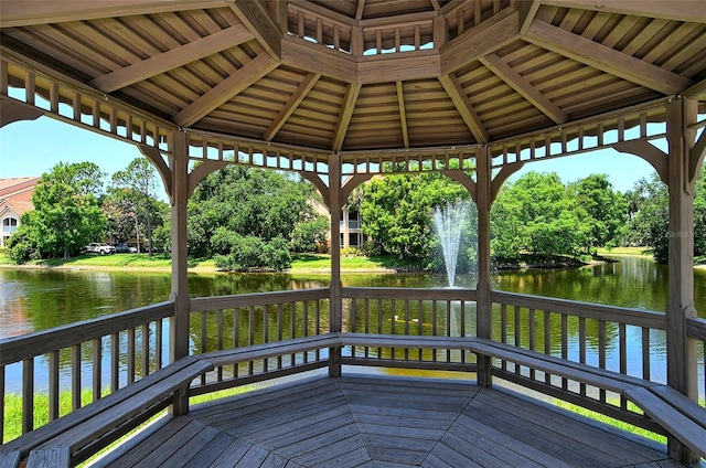 wooden deck with a water view and a gazebo