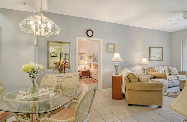 tiled dining space with ceiling fan with notable chandelier