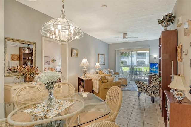 dining room featuring ceiling fan with notable chandelier and light tile patterned flooring