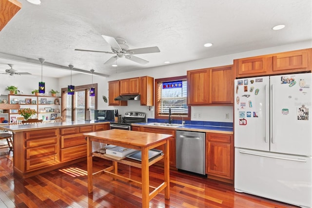 kitchen featuring pendant lighting, a healthy amount of sunlight, appliances with stainless steel finishes, and sink