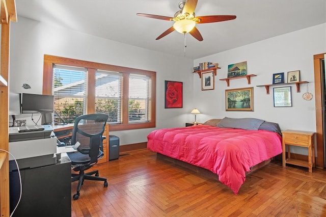 bedroom featuring ceiling fan and parquet floors