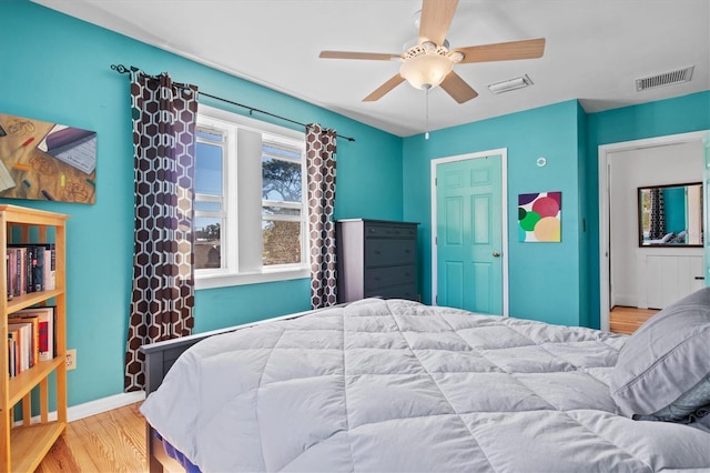 bedroom with ceiling fan and light hardwood / wood-style flooring