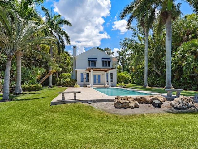 4521 Bay Shore Rd, Sarasota, FL 34234 - back of house featuring an outdoor pool, stucco siding, a lawn, french doors, and a patio area