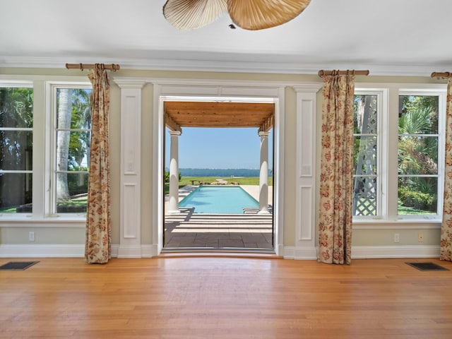 4521 Bay Shore Rd, Sarasota, FL 34234 - doorway with wood finished floors, ornamental molding, baseboards, and visible vents