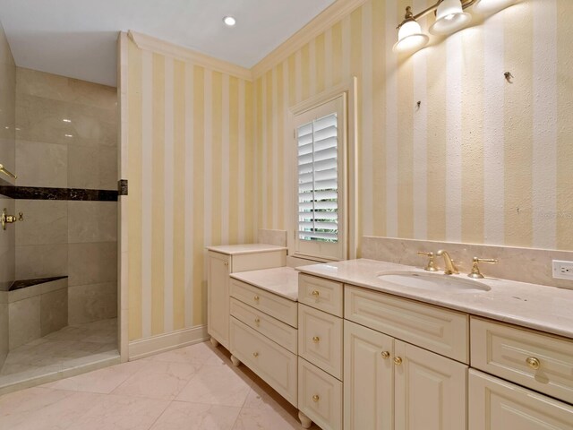 4521 Bay Shore Rd, Sarasota, FL 34234 - bathroom featuring baseboards, wallpapered walls, a tile shower, and vanity