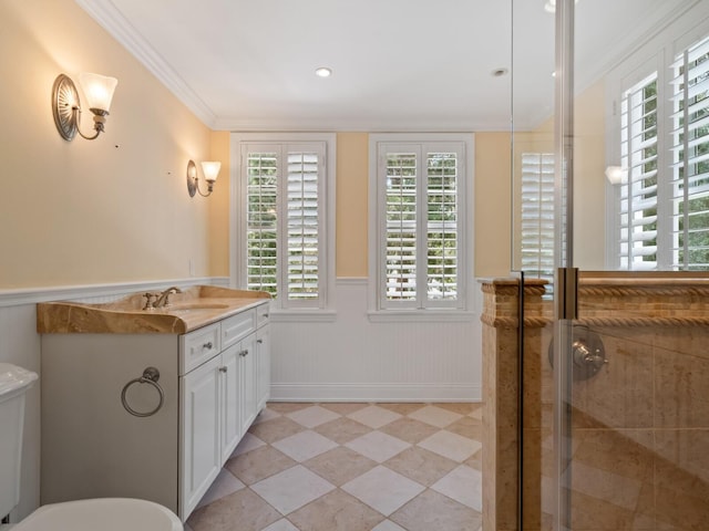 4521 Bay Shore Rd, Sarasota, FL 34234 - bathroom with crown molding, a shower stall, toilet, vanity, and wainscoting