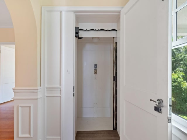 4521 Bay Shore Rd, Sarasota, FL 34234 - hall featuring arched walkways and wood finished floors