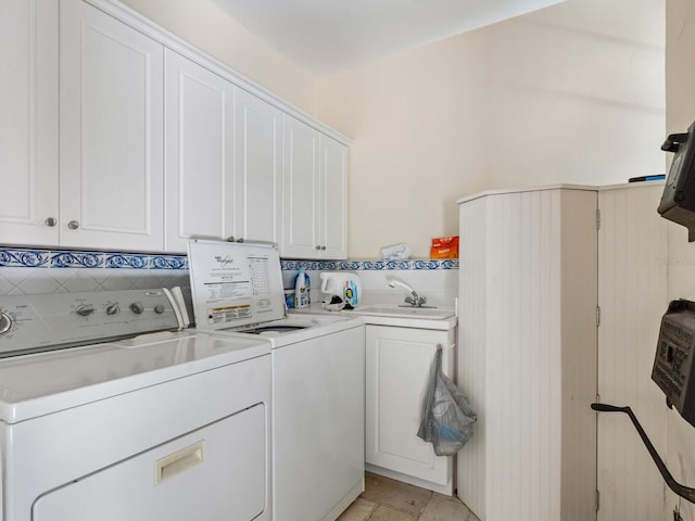 4521 Bay Shore Rd, Sarasota, FL 34234 - washroom featuring separate washer and dryer, cabinet space, and a sink