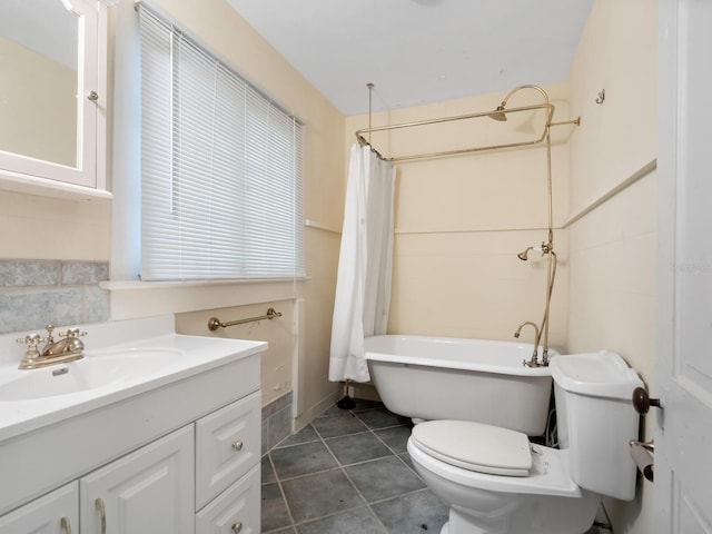 4521 Bay Shore Rd, Sarasota, FL 34234 - bathroom with toilet, tile patterned floors, and vanity