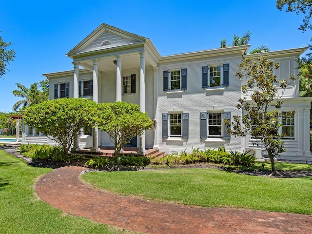 4521 Bay Shore Rd, Sarasota, FL 34234 - greek revival inspired property featuring brick siding and a front lawn