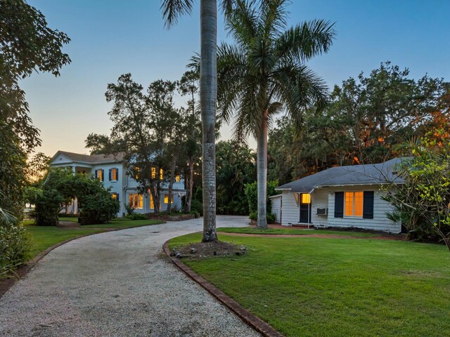 4521 Bay Shore Rd, Sarasota, FL 34234 - view of front of property with a yard and curved driveway