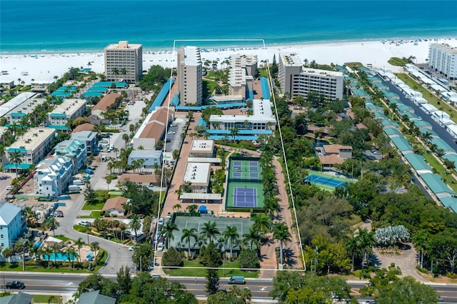 drone / aerial view featuring a water view and a view of the beach