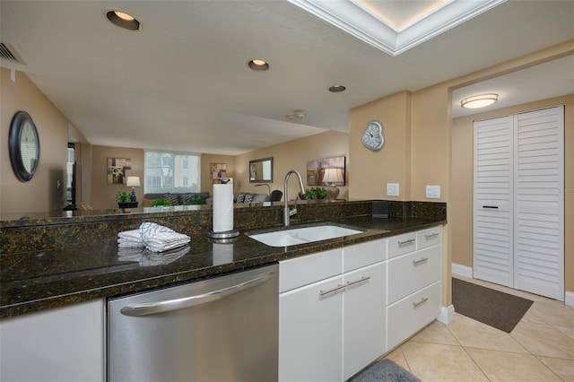 5920 Midnight Pass Rd Unit 104, Sarasota, FL 34242 - kitchen featuring stainless steel dishwasher, a sink, open floor plan, dark stone counters, and white cabinetry