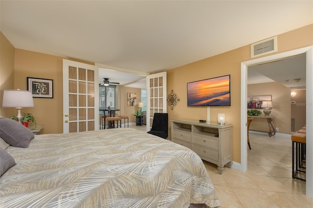 bedroom featuring light tile patterned floors and french doors