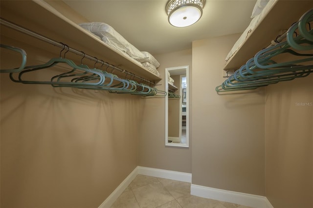 spacious closet featuring light tile patterned floors