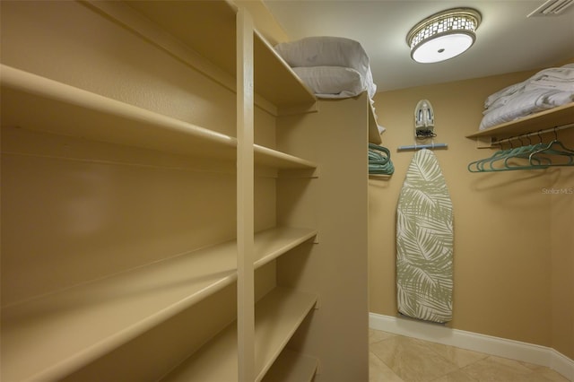 walk in closet featuring light tile patterned floors