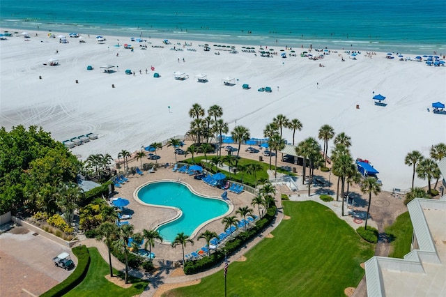 aerial view with a water view and a beach view