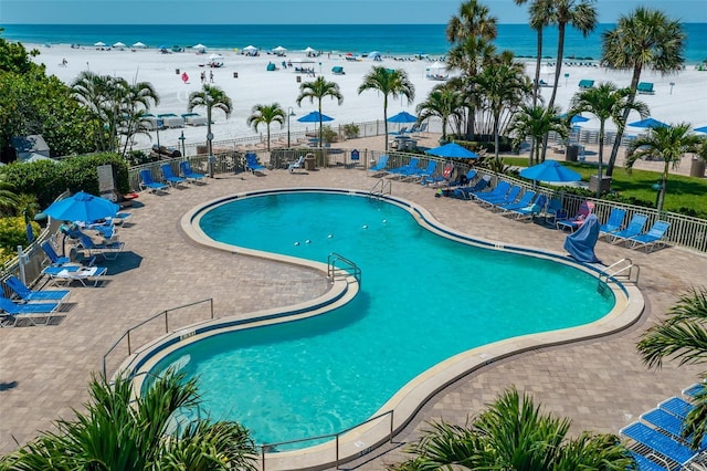 5920 Midnight Pass Rd Unit 104, Sarasota, FL 34242 - community pool featuring view of water and beach and a patio