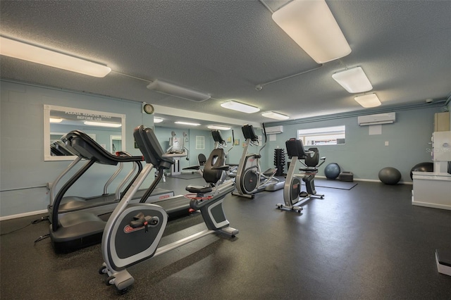 gym featuring a wall unit AC and a textured ceiling