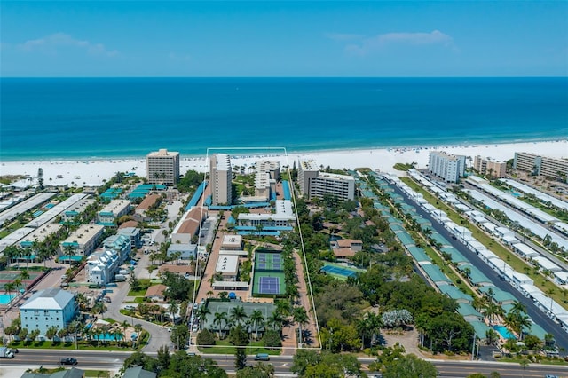 birds eye view of property featuring a water view and a beach view