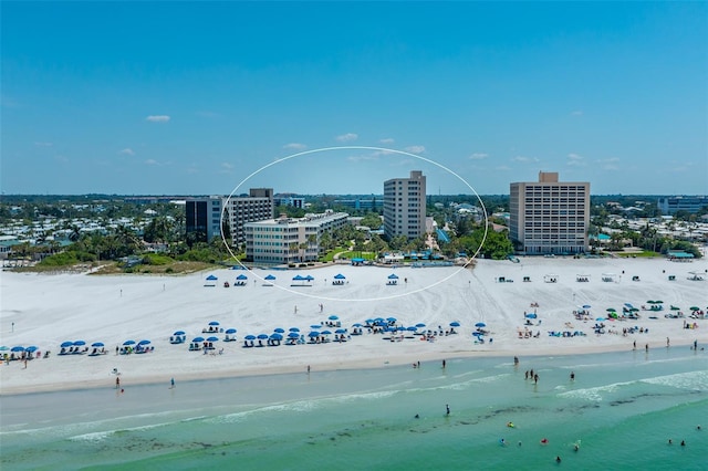 drone / aerial view featuring a view of the beach and a water view