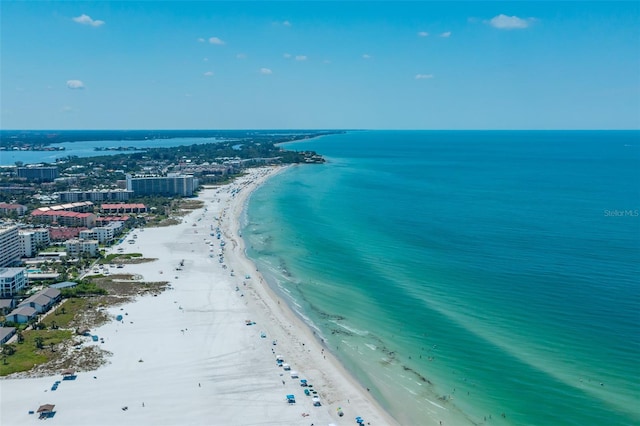 drone / aerial view featuring a water view and a beach view