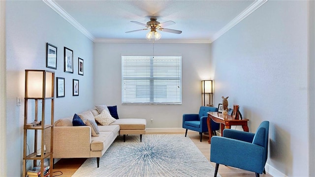 living area with hardwood / wood-style floors, ceiling fan, and crown molding