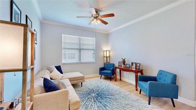 living area featuring ceiling fan, ornamental molding, and hardwood / wood-style flooring