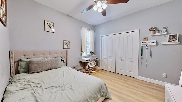 bedroom with a closet, ceiling fan, and light hardwood / wood-style flooring