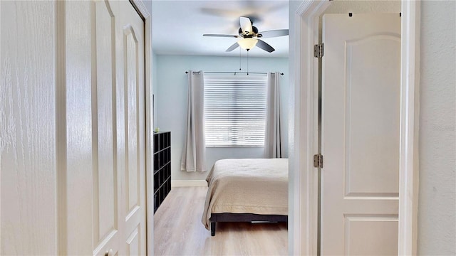 bedroom with ceiling fan and light hardwood / wood-style floors