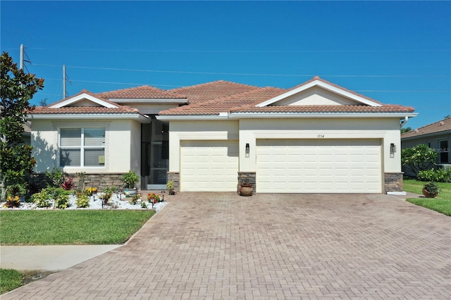 mediterranean / spanish-style home with a garage and a front yard