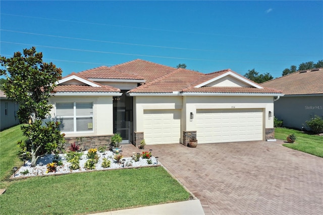 view of front of home with a garage and a front lawn