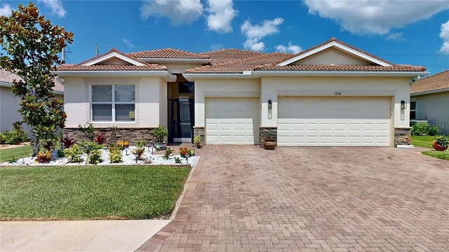 mediterranean / spanish-style home with a garage and a front lawn