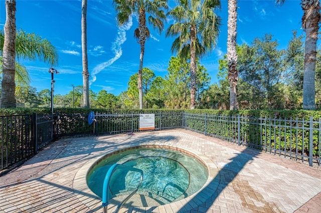 view of swimming pool featuring a patio area and a hot tub