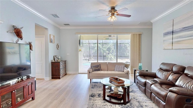 living room featuring wood-type flooring, ornamental molding, and ceiling fan