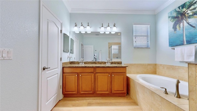 bathroom with crown molding, hardwood / wood-style flooring, dual vanity, and tiled bath