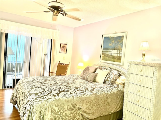 bedroom featuring ceiling fan, access to exterior, and dark hardwood / wood-style floors