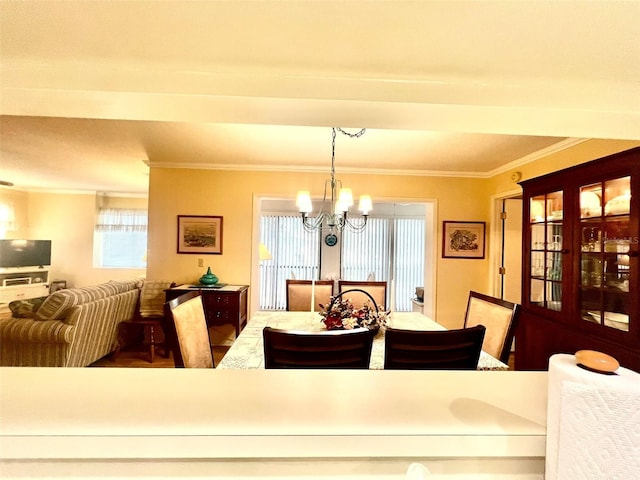 dining room featuring a chandelier and ornamental molding