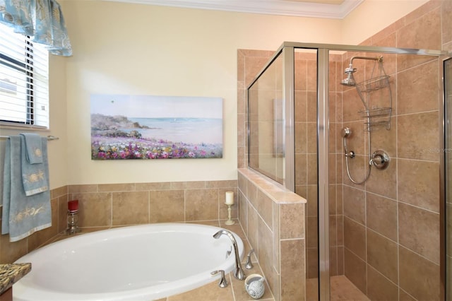 bathroom featuring ornamental molding, a garden tub, and a shower stall