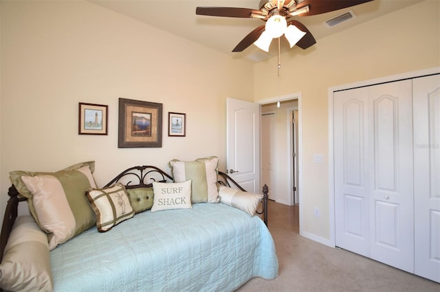 bedroom with visible vents, a ceiling fan, lofted ceiling, carpet flooring, and a closet