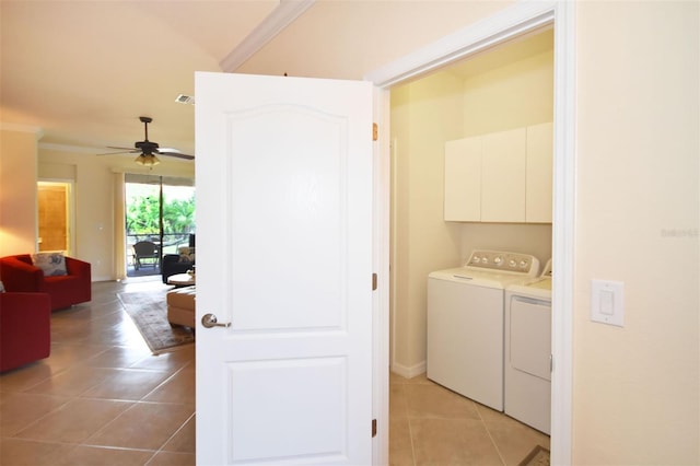 clothes washing area featuring light tile patterned floors, separate washer and dryer, a ceiling fan, cabinet space, and crown molding