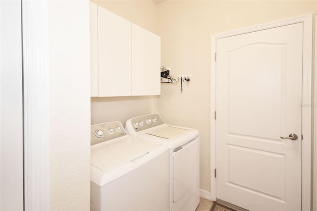 laundry room with cabinet space and separate washer and dryer