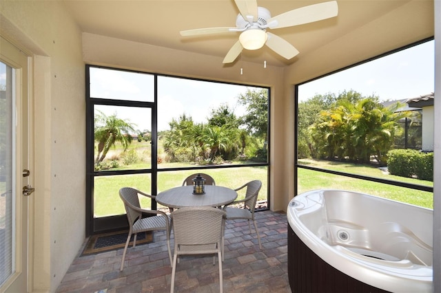 sunroom featuring ceiling fan