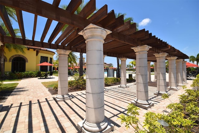 view of property's community with a pergola and a patio